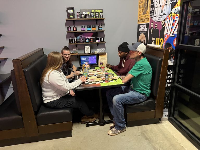 Seven Point Smoke Lab lounge seating with group of 4 people shown.
